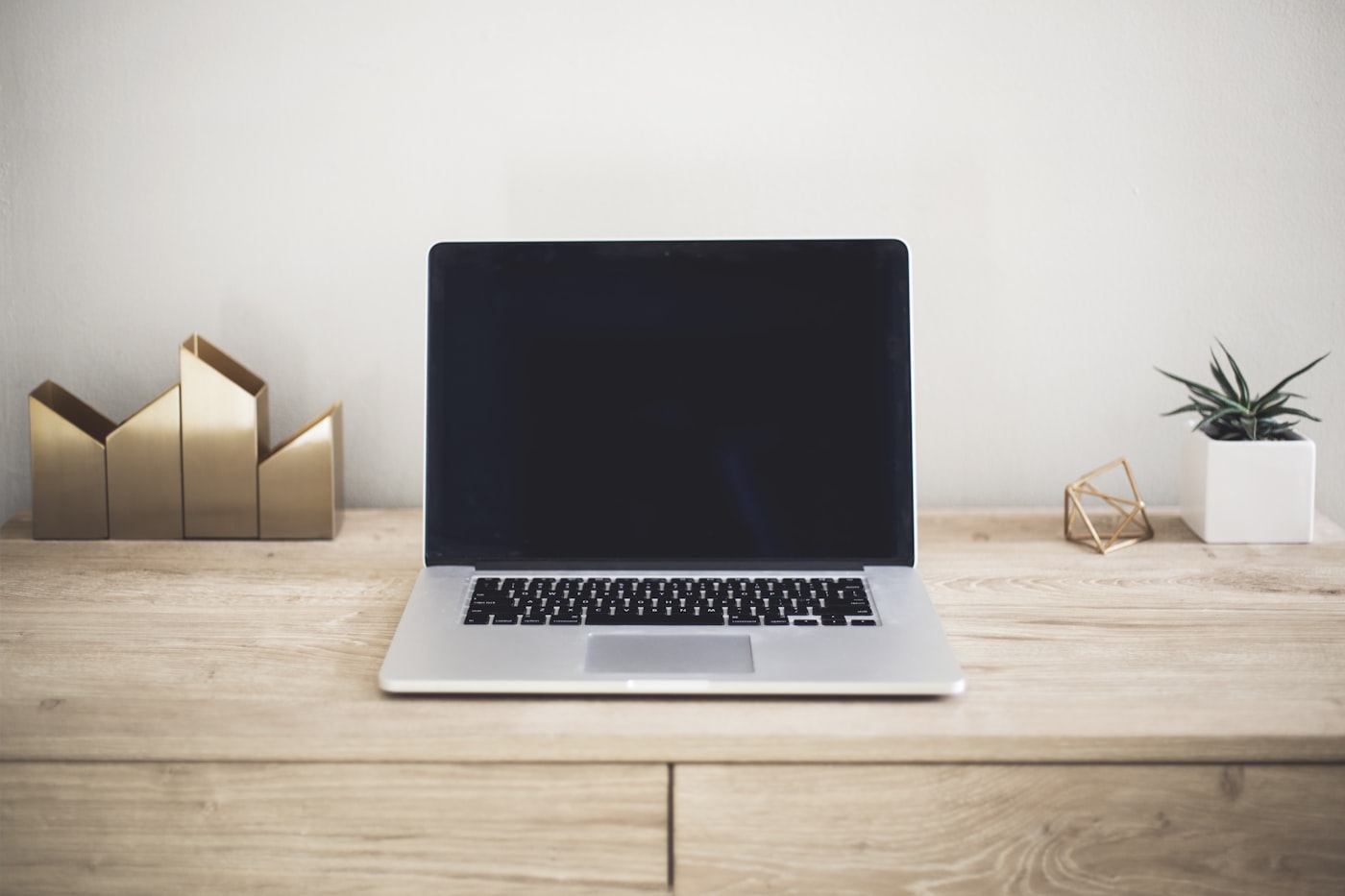 Laptop showing a website design on a clean desk workspace