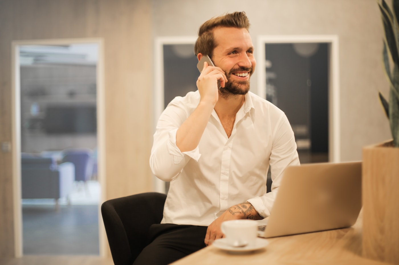 Small business owner looking at a smartphone, checking business information online
